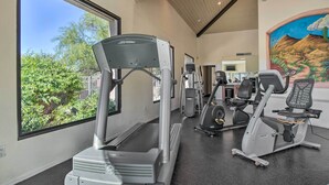 A gym with cardio equipment, a mural, and large windows. - Mountain-view Tucson Condo w/ Outdoor Pools! (Tucson)
