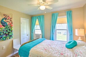 A bedroom with a bed, a ceiling fan, a window with curtains, a wall-mounted artwork, and a bedside lamp. - Modern Rapid City Duplex < 10 Mi to Natl Forest! (Rapid City)