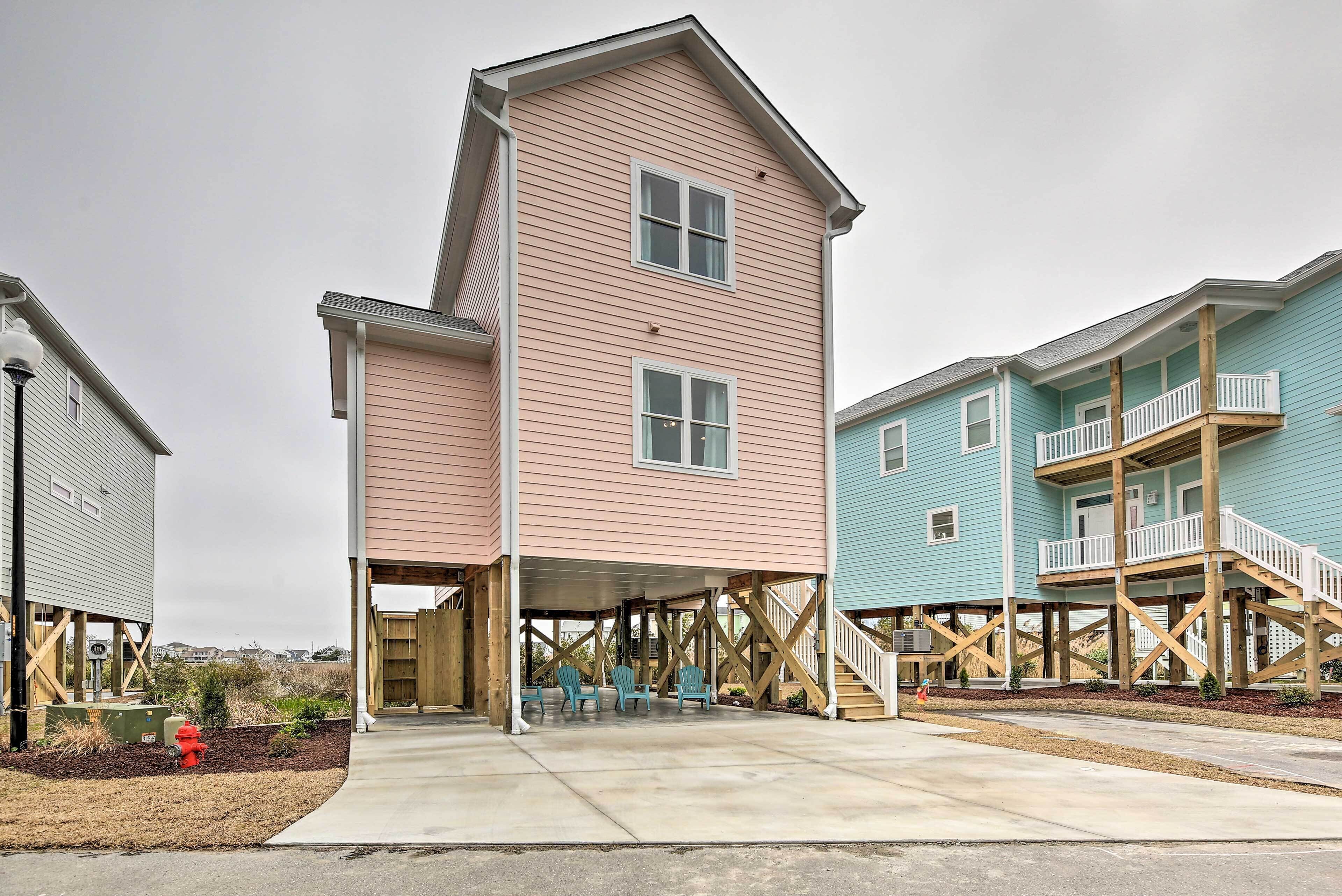 A multi-story residential building with a covered porch and a staircase leading to an upper level.