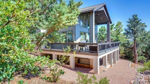 A modern two-story house with a balcony, surrounded by trees and gravel. - Hot Tub + Deck: Mtn-view Pine Getaway! (Pine)