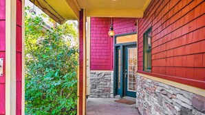 A narrow pathway leading to a building with a stone foundation and a red exterior. - Waterfront Mound Retreat w/ Dock & Lake Access! (Mound)