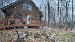 A log cabin with a balcony, surrounded by trees. - Secluded Gaylord Cabin w/ Deck, Fire Pit & Grill! (Gaylord)