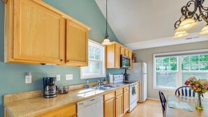 A kitchen with wooden cabinets, a dishwasher, a microwave, and a sink. - Taylorsville Lake Cottage Rental w/ Hot Tub! (Taylorsville)