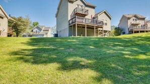 A residential building with a covered porch and a two-story structure. - Taylorsville Lake Cottage Rental w/ Hot Tub! (Taylorsville)