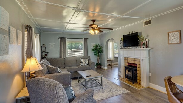 A living room with a sofa, coffee table, and a fireplace. - Lamesa Vacation Rental w/ Covered Patio & Fire Pit (Lamesa)