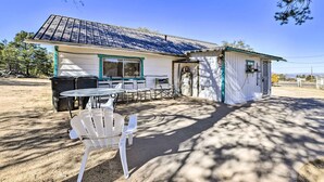 A small building with a covered patio, outdoor seating, and a trash can. - Charming Miami Desert Escape w/ Yard + Patio! (Miami)