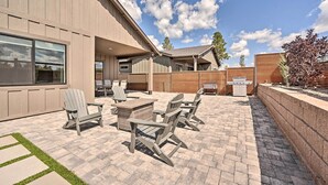 An outdoor patio with Adirondack chairs, a table, and a grill. - Flagstaff Retreat w/ Covered Patio, 3 Mi to Dtwn (Flagstaff)