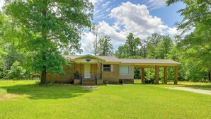 A single-story building with a covered porch, a front door, and a small window. - North Carolina Getaway Near Kayaking & Fishing! (Oriental)