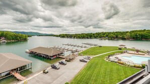 A marina with docked boats, a swimming pool, and a parking area.
