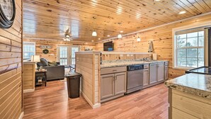 A wooden cabin interior with a kitchen, dining area, and a living room. - Cozy Elmira Cabin ~ 23 Mi to Boyne Mountain Resort (Mancelona)