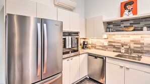 A modern kitchen with stainless steel appliances, a built-in oven, and a dishwasher. - Contemporary-boho Loft in Downtown Livingston! (Livingston)