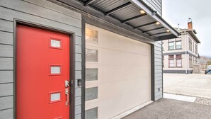 A garage door with a red door and multiple windows. - Contemporary-boho Loft in Downtown Livingston! (Livingston)