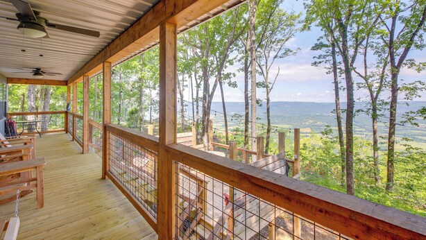 A wooden deck with a railing overlooking a forested landscape. - Renovated Cabin w/ Decks, Views, & Fire Pit! (Pikeville)