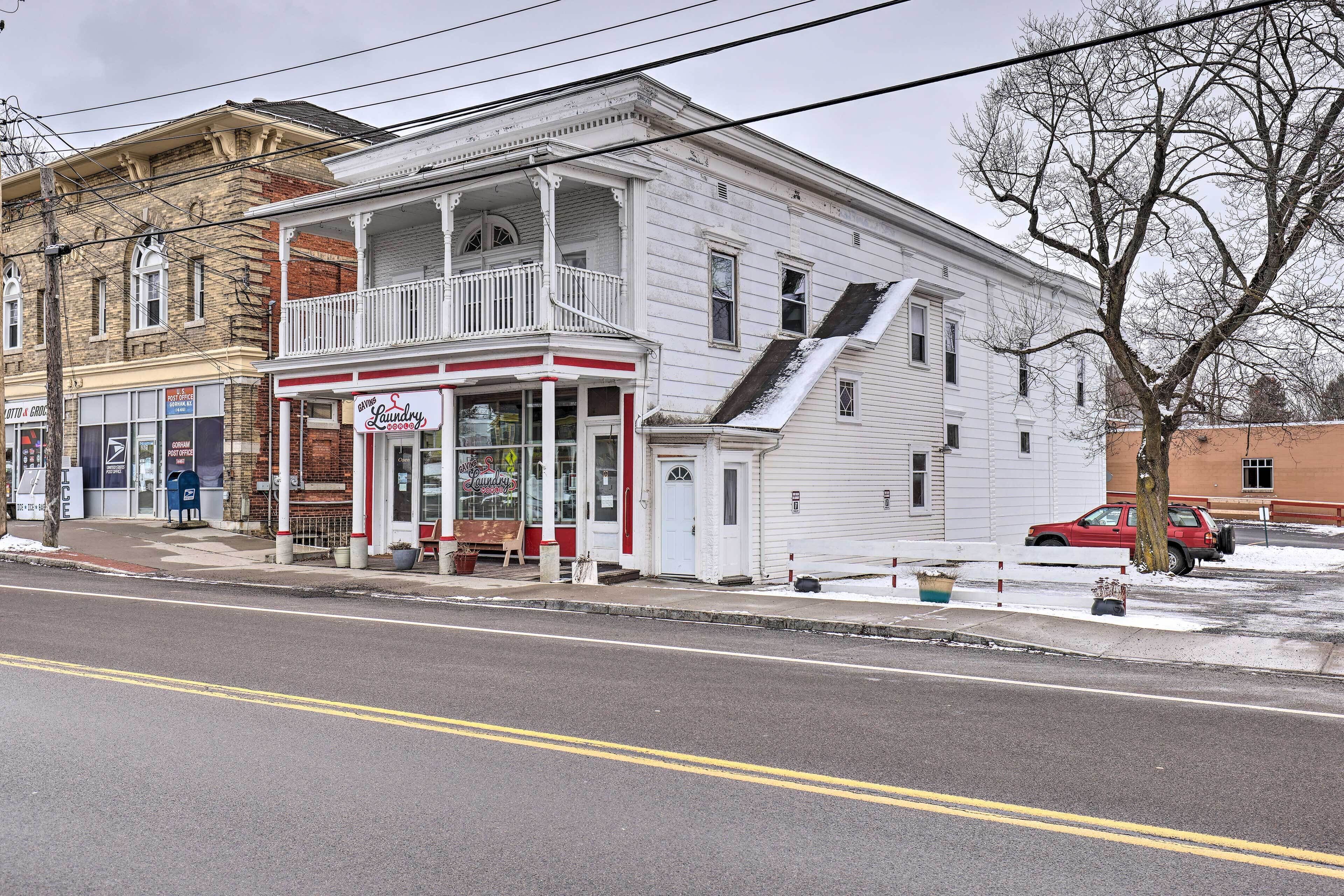 A two-story building with a balcony and a storefront.