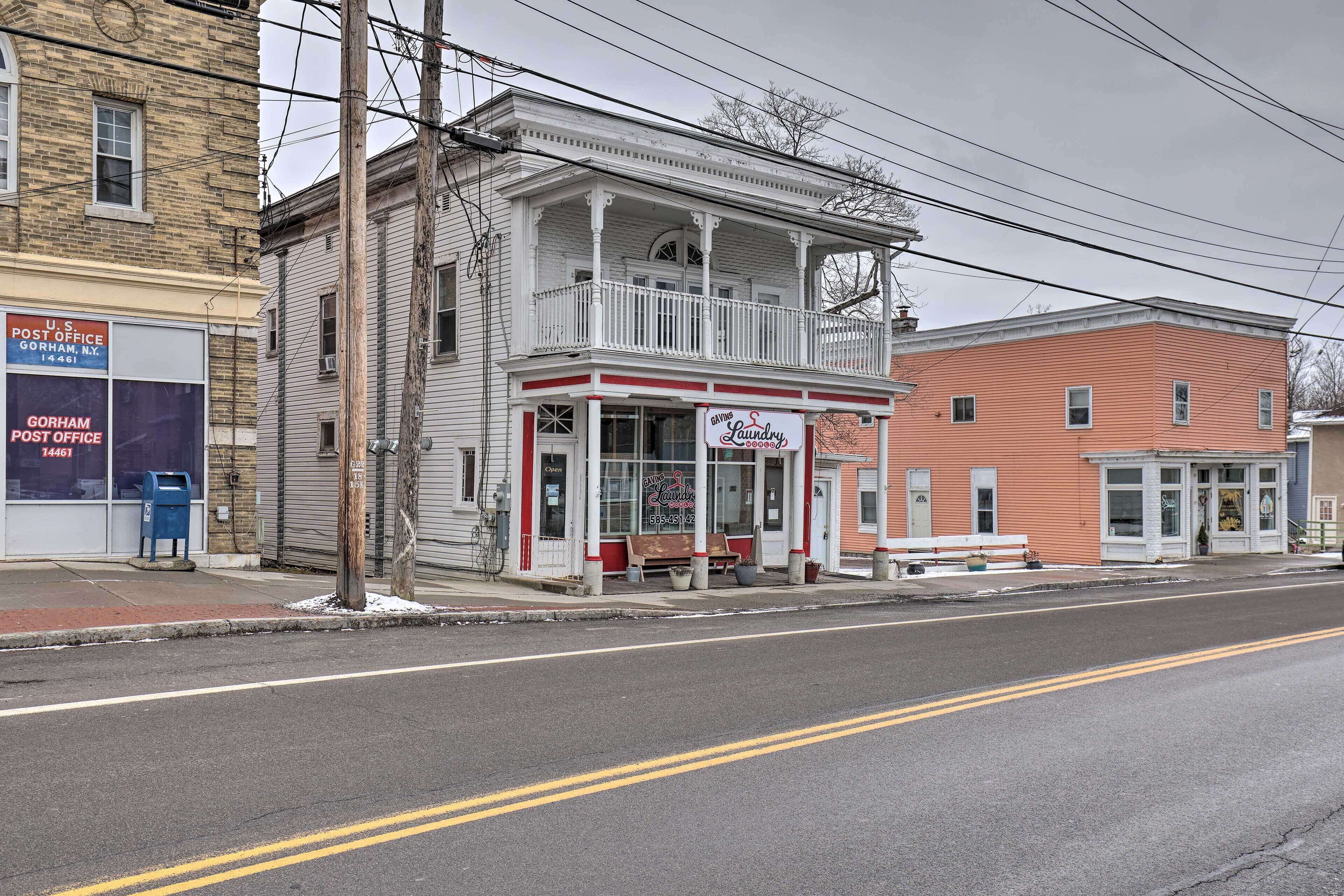 A two-story building with a porch and a storefront.