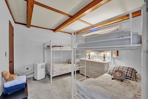 A bunk bed room with a white dresser, a heater, and a blue chair. - Poconos Retreat w/ Pool and Lake Access (Lake Ariel)