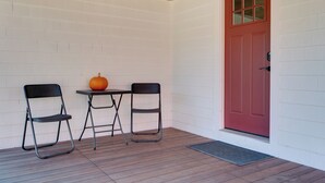 A corner of a room with a red door, white walls, and a wooden ceiling. - Walk to Village! Family-friendly Gem in East Burke (East Burke)