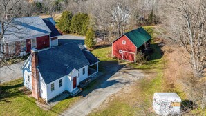 A rural property with a white house, a red barn, and a green-roofed shed. - Walk to Village! Family-friendly Gem in East Burke (East Burke)
