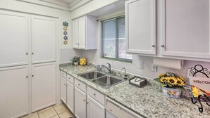 A kitchen with white cabinets, a granite countertop, a double sink, and a window with blinds. - 2 Mi to Lake Havasu: Peaceful Home w/ Pool & Views (Lake Havasu City)