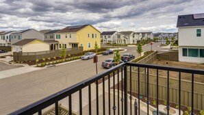 A residential street with houses, a clear sky, and a stop sign. - California Midterm Rental With Fenced Yard! (Tracy)