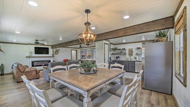 A spacious dining area with a wooden table and chairs, a ceiling fan, and recessed lighting. - Eufaula Retreat w/ Lake Views: Walk to Marina (Eufaula)