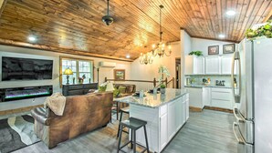 A spacious kitchen with a central island, wooden ceiling, and modern appliances. - Otto Home w/ Fire Pit, Tree House & Hot Tub! (Otto)