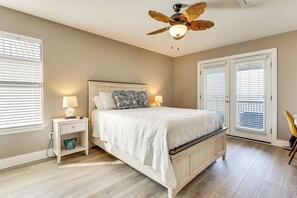 A bedroom with a bed, nightstands, a ceiling fan, and a window with blinds. - Foley Beach Cottage w/ Waterfront Backyard! (Foley)
