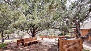An outdoor patio area with a wooden bench, a table, and a grill. - 6 Mi to Red Rock State Park: Home w/ Patio & Yard (Sedona)