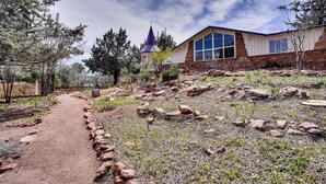 A building with a stone facade, large windows, and a distinctive spire. - 6 Mi to Red Rock State Park: Home w/ Patio & Yard (Sedona)