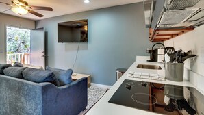 A modern kitchen with a built-in stove, a ceiling fan, and a flat-screen TV mounted on the wall. - 6 Mi to Red Rock State Park: Home w/ Patio & Yard (Sedona)