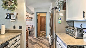 A kitchen with a stainless steel refrigerator, a toaster, and a dishwasher. - Relaxing Deck & Grill: Pinetop Townhome! (Pinetop)