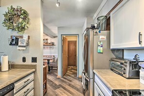 A kitchen with a stainless steel refrigerator, a toaster, and a dishwasher. - Relaxing Deck & Grill: Pinetop Townhome! (Pinetop)