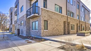A multi-story residential building with a brick facade, balconies, and large windows. - Boise Townhome w/ Rooftop Deck, 2 Mi to Downtown! (Boise)