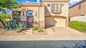 A two-story house with a garage, a front entrance with a door, and a small balcony. - Cave Creek Retreat w/ Private Pool & Hot Tub! (Cave Creek)