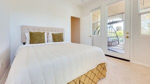 A bedroom with a bed, a door leading to a balcony, and a window. - Family-friendly Camarillo Home w/ Access to Pools! (Camarillo)
