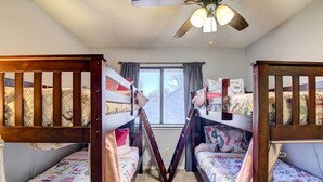 A room with two bunk beds, a window, and a ceiling fan. - 4 Mi to Joe Pool Lake: Home in Grand Prairie (Grand Prairie)