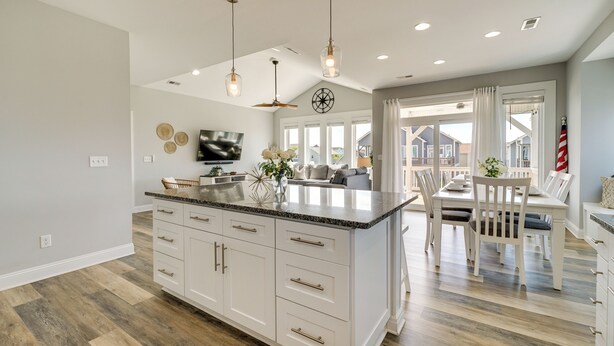 A spacious kitchen with white cabinetry, a large island, and pendant lighting. - Modern Surf City Beach House w/ Hot Tub! (Holly Ridge)