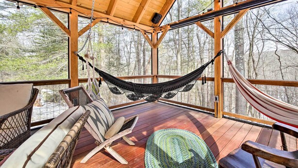 A wooden deck with a hammock, wicker chairs, and a view of trees. - West Cornwall Cabin ~ 4 Mi to Covered Bridge! (West Cornwall)
