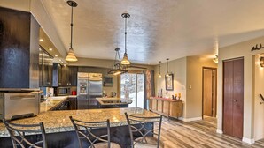 A modern kitchen with granite countertops, stainless steel appliances, and pendant lighting. - Private Sauna & Mtn Views: Idaho Springs Gem (Idaho Springs)