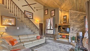 A cozy living room with a staircase, a fireplace, and a comfortable seating area. - Private Sauna & Mtn Views: Idaho Springs Gem (Idaho Springs)