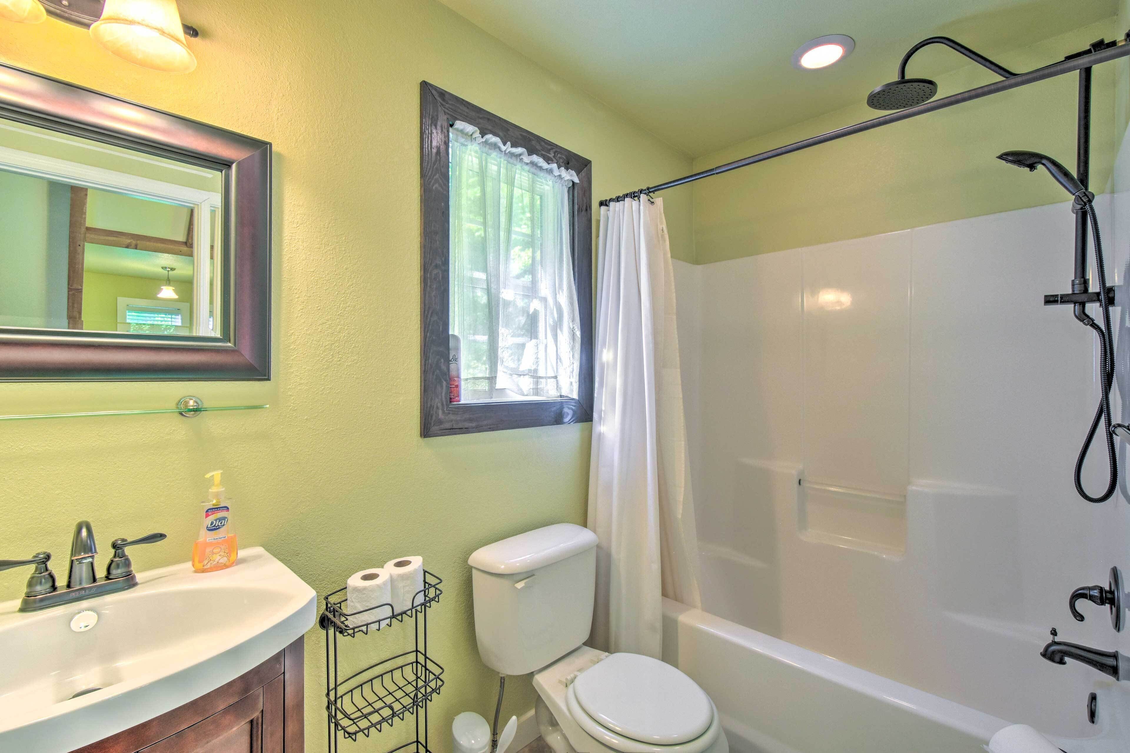 A bathroom with a sink, toilet, and bathtub.