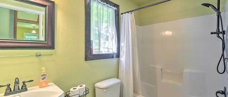 A bathroom with a sink, toilet, and bathtub.