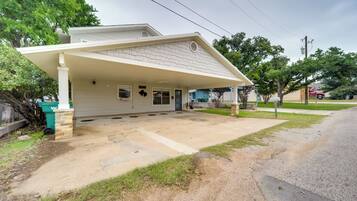 A single-story house with a covered porch, a garage, and a driveway.