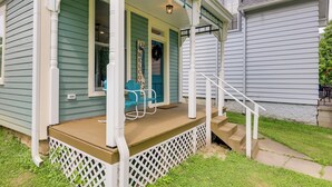 A porch with a wooden deck, a white railing, and a set of stairs leading to the entrance. - Historic Madison Retreat - 1 Mi to Ohio River (Madison)