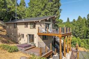 A multi-story building with a deck and outdoor seating area, surrounded by trees. - Hot Tub + Scenic Views: Luxury Twain Harte Cabin! (Twain Harte)