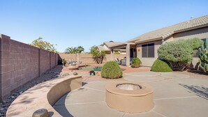 A patio with a fire pit, seating areas, and a pool. - Avondale Getaway < 8 Mi to Estrella Mountain! (Avondale)