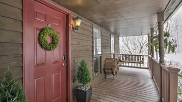 Step out onto the covered porch, where a cozy bench invites you to sit and enjoy the surroundings.