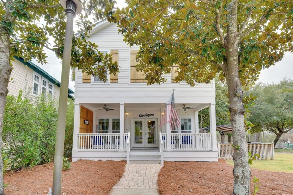 A two-story house with a porch, a sign reading "Sandpiper," and an American flag. - Sunny Santa Rosa Beach in 30 A Neighborhood! (Santa Rosa Beach)