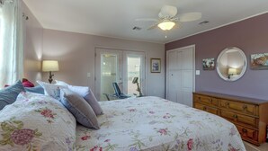 A bedroom with a bed, a dresser, a chair, a ceiling fan, and a door with blinds. - Pool & Amazing View: Updated Grand Lake Getaway (Grove)