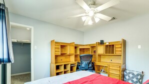 A bedroom with a bed, a desk, a chair, and a wardrobe. - New Braunfels Escape, Walk to Gruene Hall! (New Braunfels)